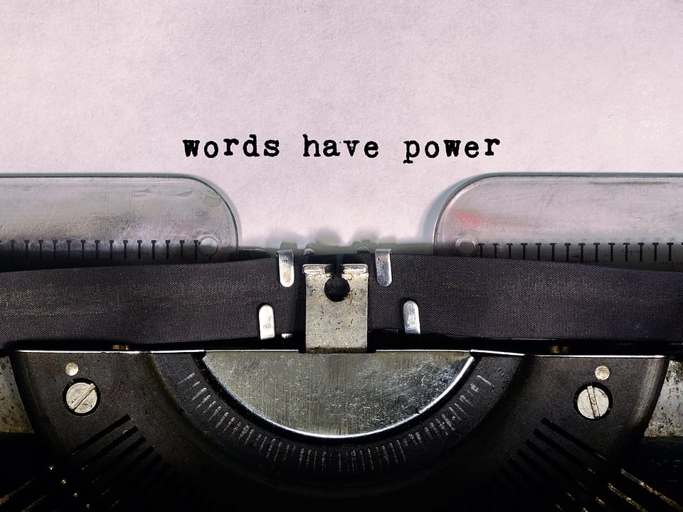 Single Word, Authority, Persuasion, Communication, Text. Typewriter with the phrase "Words have power" written on a piece of paper above the ribbon.